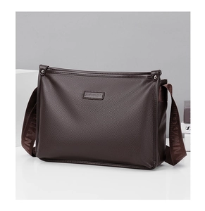 Detailed view of dark coffee pebbled leather texture on a large capacity shoulder bag