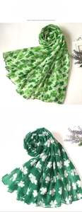 Detail of St. Patrick's Day silk scarf with green clover print on voile fabric