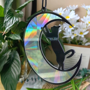 Macro detail of suncatcher black cat on moon with vibrant rainbow prism reflection effect