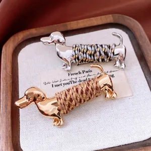 Chic dachshund brooches with gold and silver finishes and colorful cord wrapping
