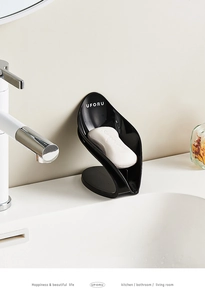 Detail of leaf-shaped self-draining soap holder in black finish for bathroom vanity