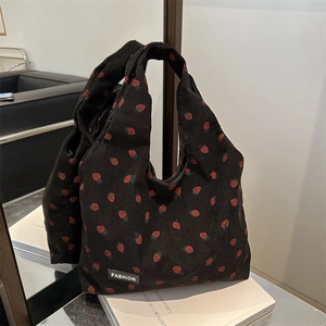 Corduroy tote bag with strawberry print and black strap for casual everyday use