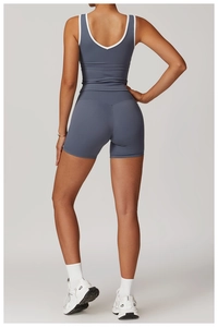 Rear view of deep grey-blue cross back yoga set with contrast white edge trim