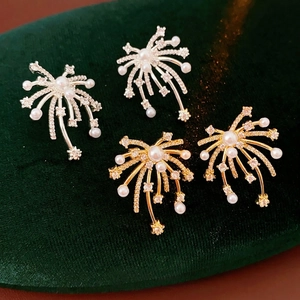 18K gold plated fireworks stud earrings with white pearls and zircons on green velvet