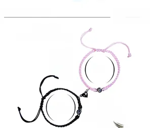 Detail of adjustable couple bracelets with heart magnetic clasp and projection stone