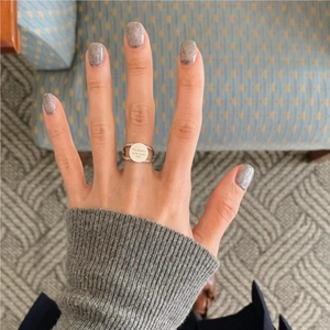 925 sterling silver woven twist ring with engraved round plate on a model hand