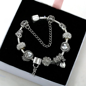 Close-up of silver plated charm bracelet with heart beads and LOVE pendant in gift box