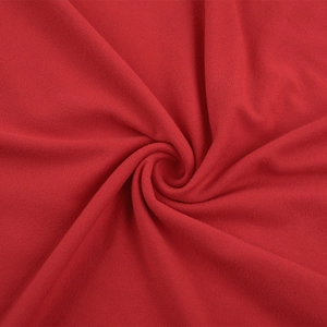 Detailed macro view of high-quality red knitted fabric showing soft texture and fine fibers