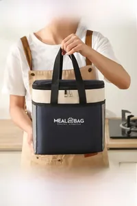 Detail of the navy and beige insulated lunch bag with side mesh pockets and widened handles
