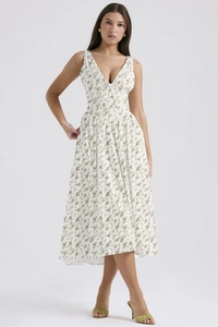Detailed close-up of a white floral V-neck midi dress with delicate green flower prints