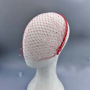 Close-up of red birdcage veil headband with sparkling rhinestones for bridal parties