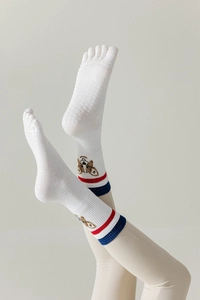 Detail of white cotton yoga toe socks with corgi embroidery and anti-slip grip dots