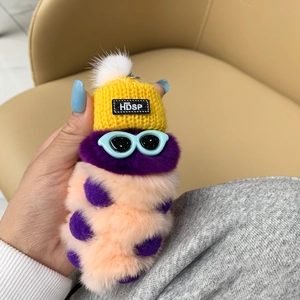 Detail of cute purple and pink plush caterpillar keychain with a yellow knit hat