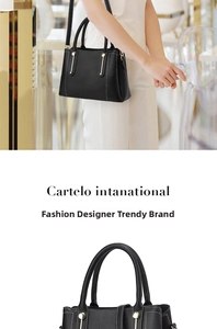 Detail of black litchi pattern leather handbag with gold studs and shoulder strap