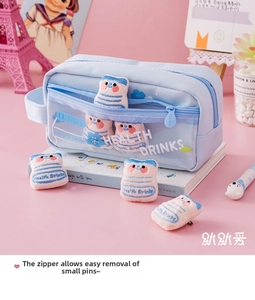 Detail of light blue canvas pencil case with transparent mesh and plush drink charms