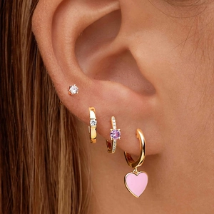 Close-up of stacked S925 silver gold-plated hoop earrings with zircon and heart charms