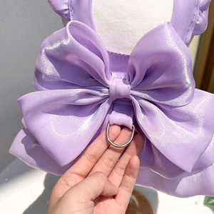 Close-up of purple satin pet dress showing a large bow detail and metal D-ring for leash