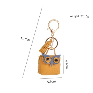 Creative yellow leather owl coin purse keychain with blue eye mask and tassel detail