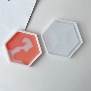 Detail of a marble pattern coaster and a translucent hexagonal silicone mold