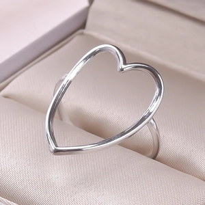 Detailed macro view of a silver minimalist open ring with large hollow heart design