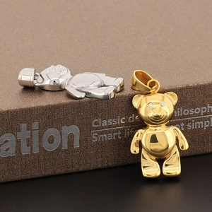 Macro shot of hip-hop panda pendants in gold and silver with iced-out rhinestone eyes