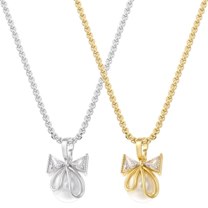 Detail view of pearl bow necklaces in gold and silver finish with zircon accents