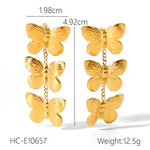 Detailed view of butterfly drop earrings in gold finish showing dimensions and weight