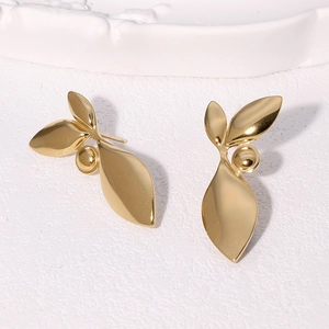 Elegant 18k gold plated stainless steel leaf earrings on a textured white surface