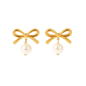 Detail view of gold bow knot earrings with white pearl accents in a polished finish