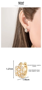 Detail view of gold hoop earrings with square zircon clusters and exact dimensions