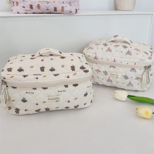 Quilted makeup bags with cartoon bread dog and elephant patterns in creamy white