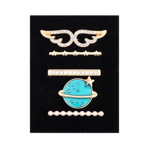 Detail view of five gold charms with wings, stars, and pearls for silicone watch bands