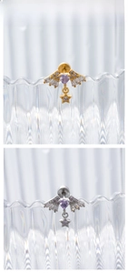 Detail of angel wing earrings with heart amethyst and star charms in gold and silver