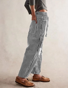 Detailed side view of black and white striped trousers with drawstring and side pocket