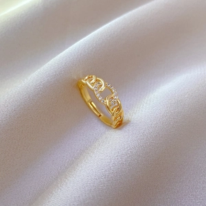 Elegant gold chain ring with zircon inlay and adjustable band on silk background