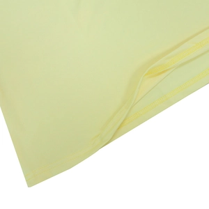 Detail view of the yellow maxi dress showing smooth fabric texture and neat double stitching