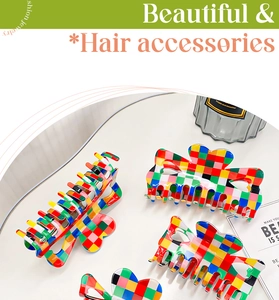 Detail of colorful checkerboard hair claw clip with heart-shaped cutout on a white table
