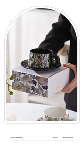 Close-up of ceramic iris coffee cup and matching saucer in a decorative gift box