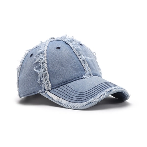 Unstructured light blue denim baseball cap with distressed frayed edges and breathable holes