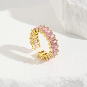 Detailed view of gold-plated adjustable ring with pink rectangular cubic zirconia stones