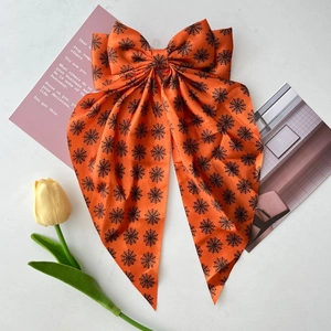 Halloween orange satin hair bow with black spider web pattern for festive parties