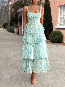 Detail view of tiered layered skirt and light blue floral pattern on chiffon dress