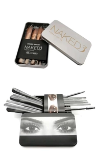 Detailed view of 12-piece makeup brush set inside a branded sleek metal storage tin