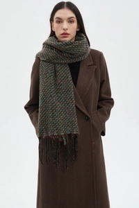 Close-up of a colorful mixed checkered scarf with fringe details and warm fabric texture