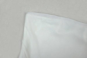 Close-up of white mesh fabric texture showing fine mesh structure and transparency