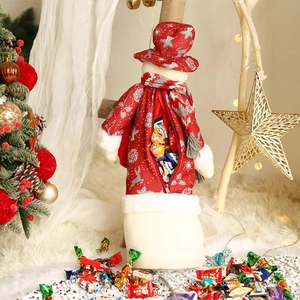 Christmas reindeer candy storage bag with white plush trim next to a festive tree