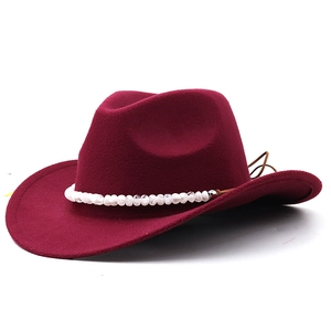 Detail of burgundy felt cowboy hat with beaded band and adjustable leather drawstring