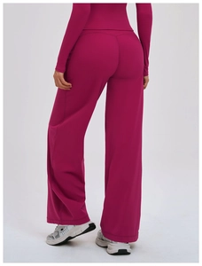 Rear view of rose pink high-waist wide-leg athletic pants with smooth draped fabric