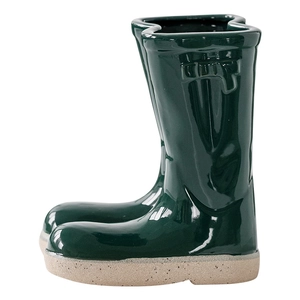 Creative dark green ceramic boot-shaped planter with a stylish glazed finish and beige base