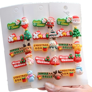 Detail shot of Santa Claus and reindeer hair clip set on a white card background